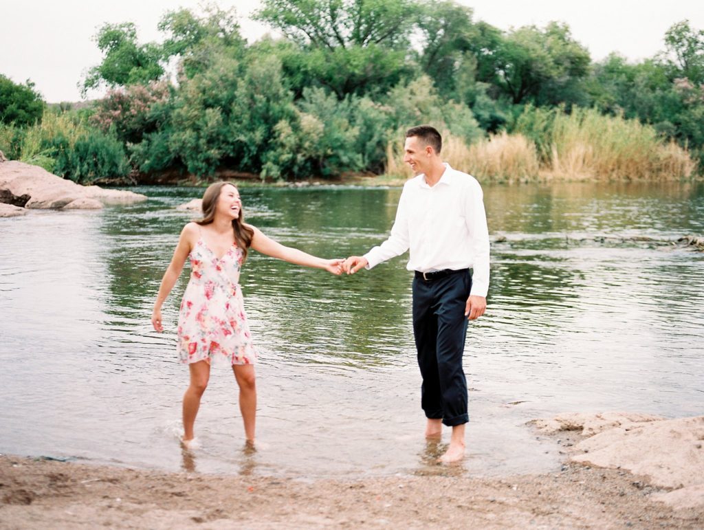 couple in salt river being playful 