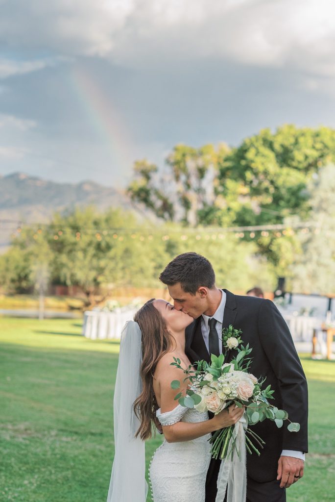 bride and groom with rainbow 