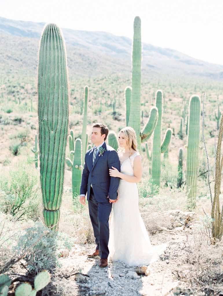 bride and groom surrounded by cactus