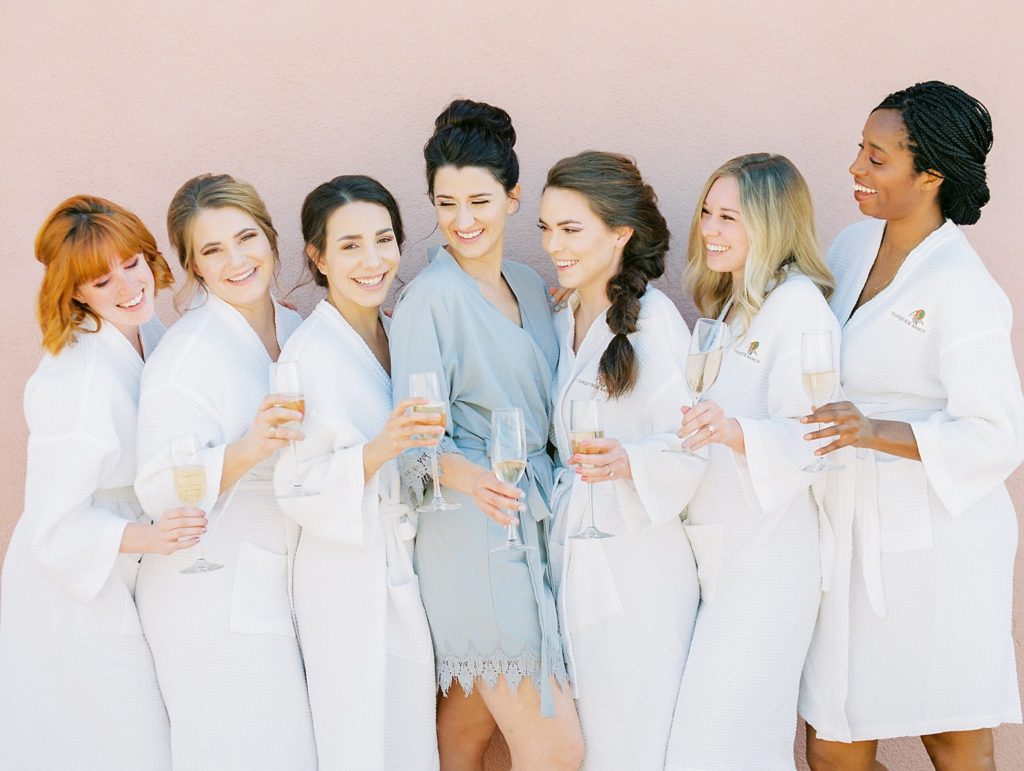 bride and bridesmaids champagne toast 